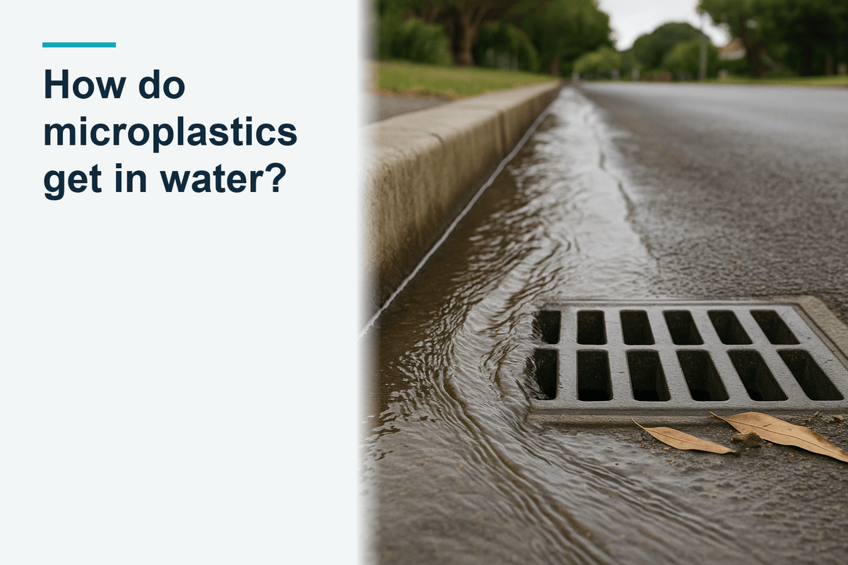 Rainwater runoff flowing along a street gutter into a stormwater grate, shallow runoff running downhill along the kerb after rain, australian suburban street
