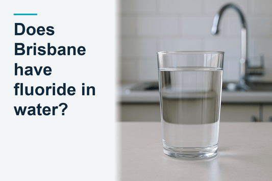 A filled clear glass of tap water standing on a benchtop, a filled glass of tap water standing completely still, australian home kitchen
