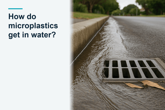 Rainwater runoff flowing along a street gutter into a stormwater grate, shallow runoff running downhill along the kerb after rain, australian suburban street