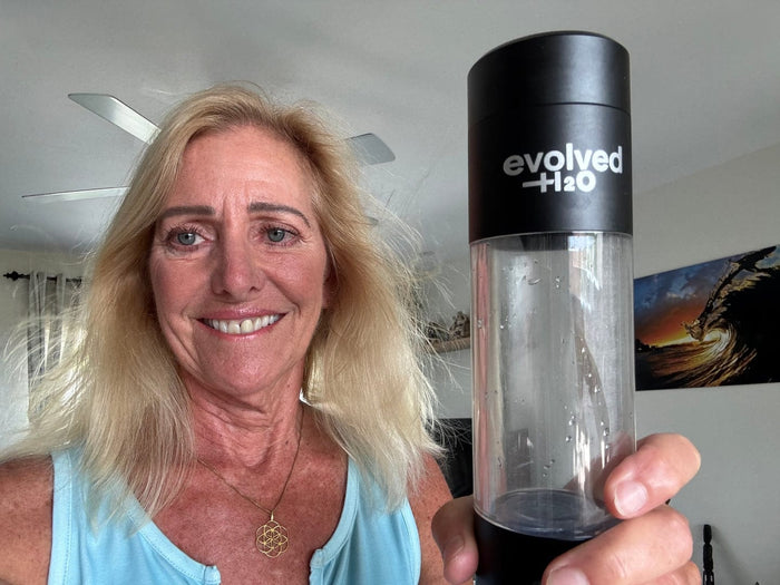 Customer holding the Evolved H2O hydrogen water bottle