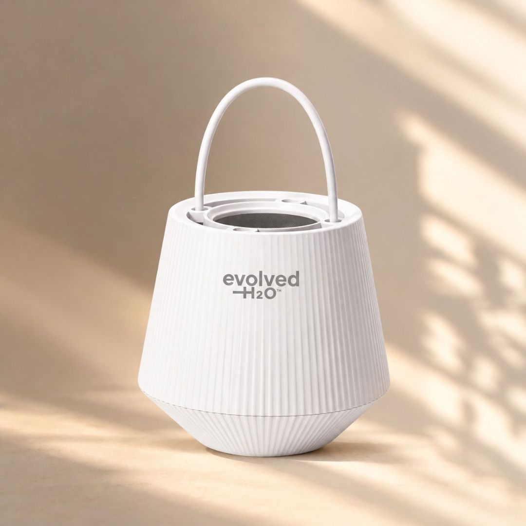 Evolved H2O bath filter in white with carry handle, displayed in warm natural bathroom light