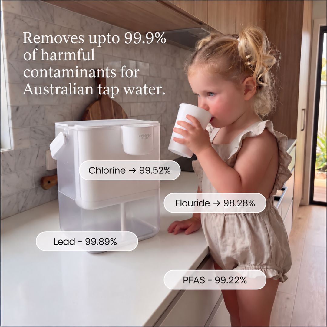 Child drinking filtered water beside the Evolved H2O HydroX electric water filter, highlighting tested reductions for chlorine, fluoride, lead and PFAS