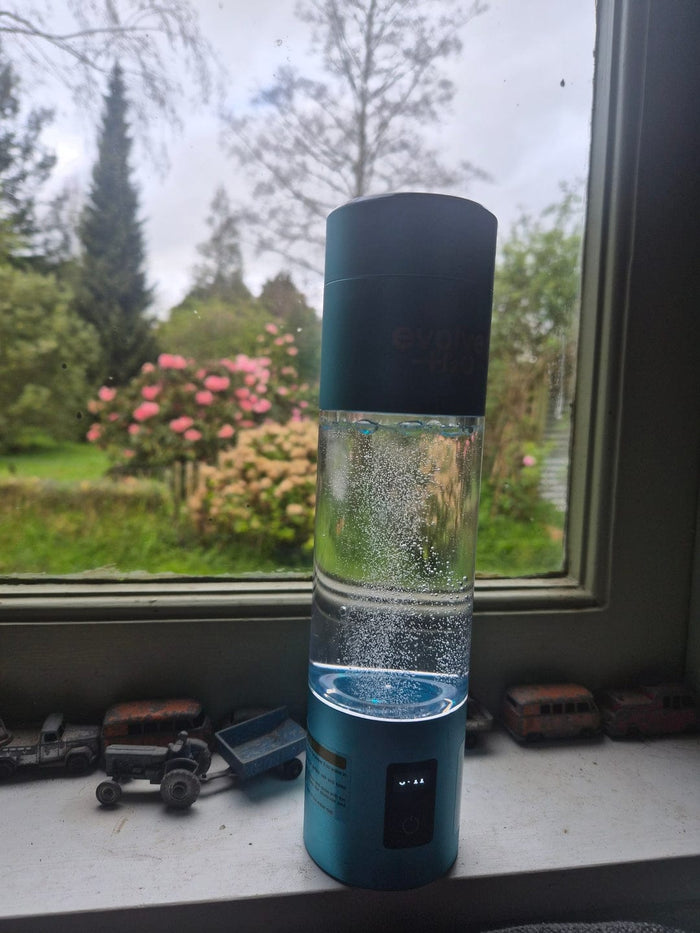 Customer photo of the Evolved H2O hydrogen water bottle producing hydrogen near a window